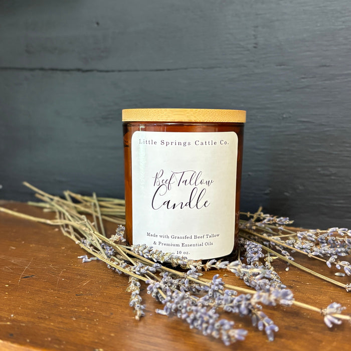 A beef tallow candle surrounded by lavender